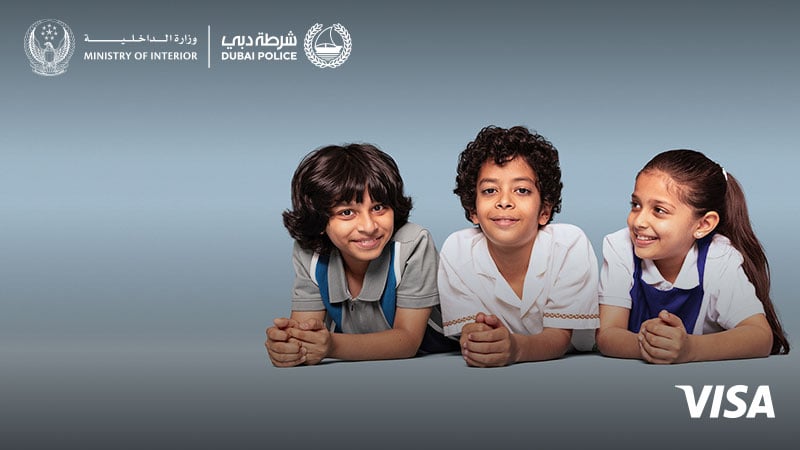 Two children look directly at the camera, one child looks at the two children