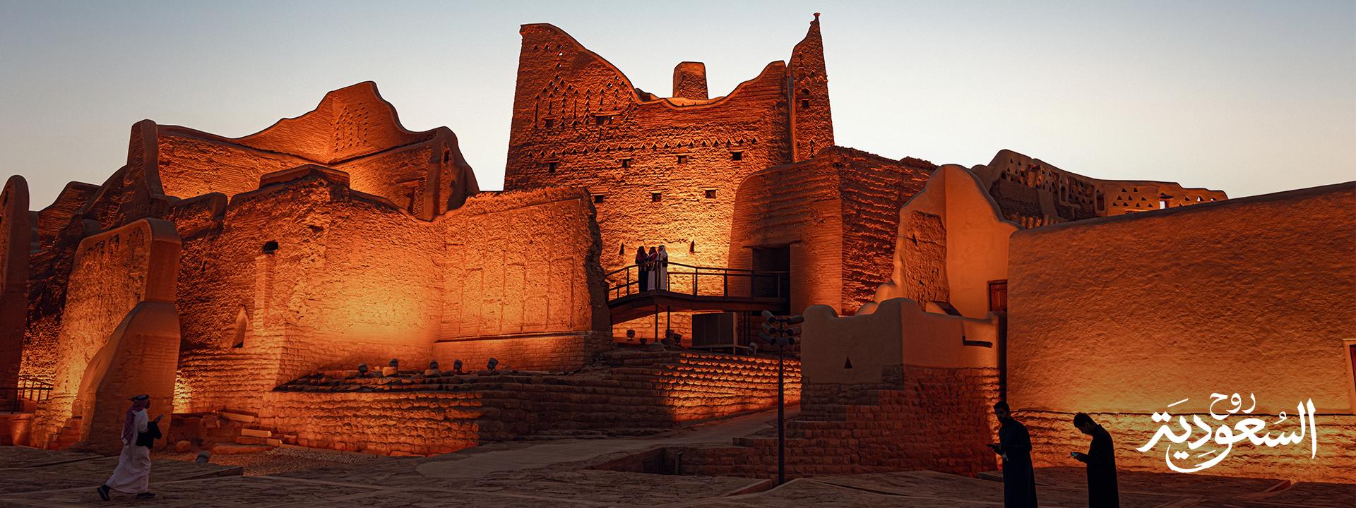 Ancient buildings in Diriyah. text in the corner: "Saudi. Welcome to Arabia"