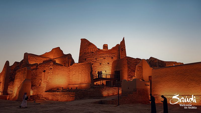 Ancient buildings in Diriyah. text in the corner: "Saudi. Welcome to Arabia"